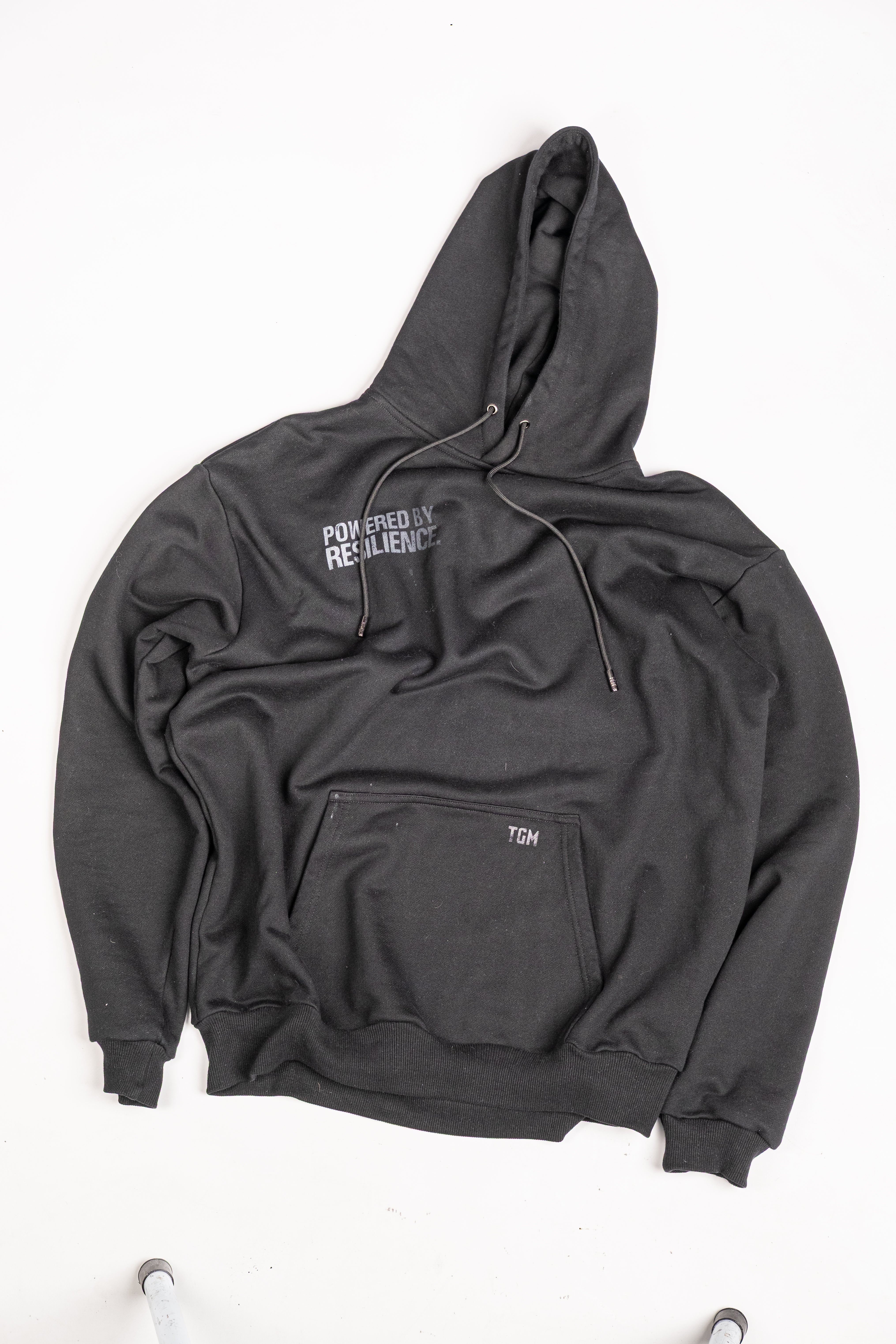 Black Oversized Hoodie with White gradient text saying powered by resilience. 100% premium cotton