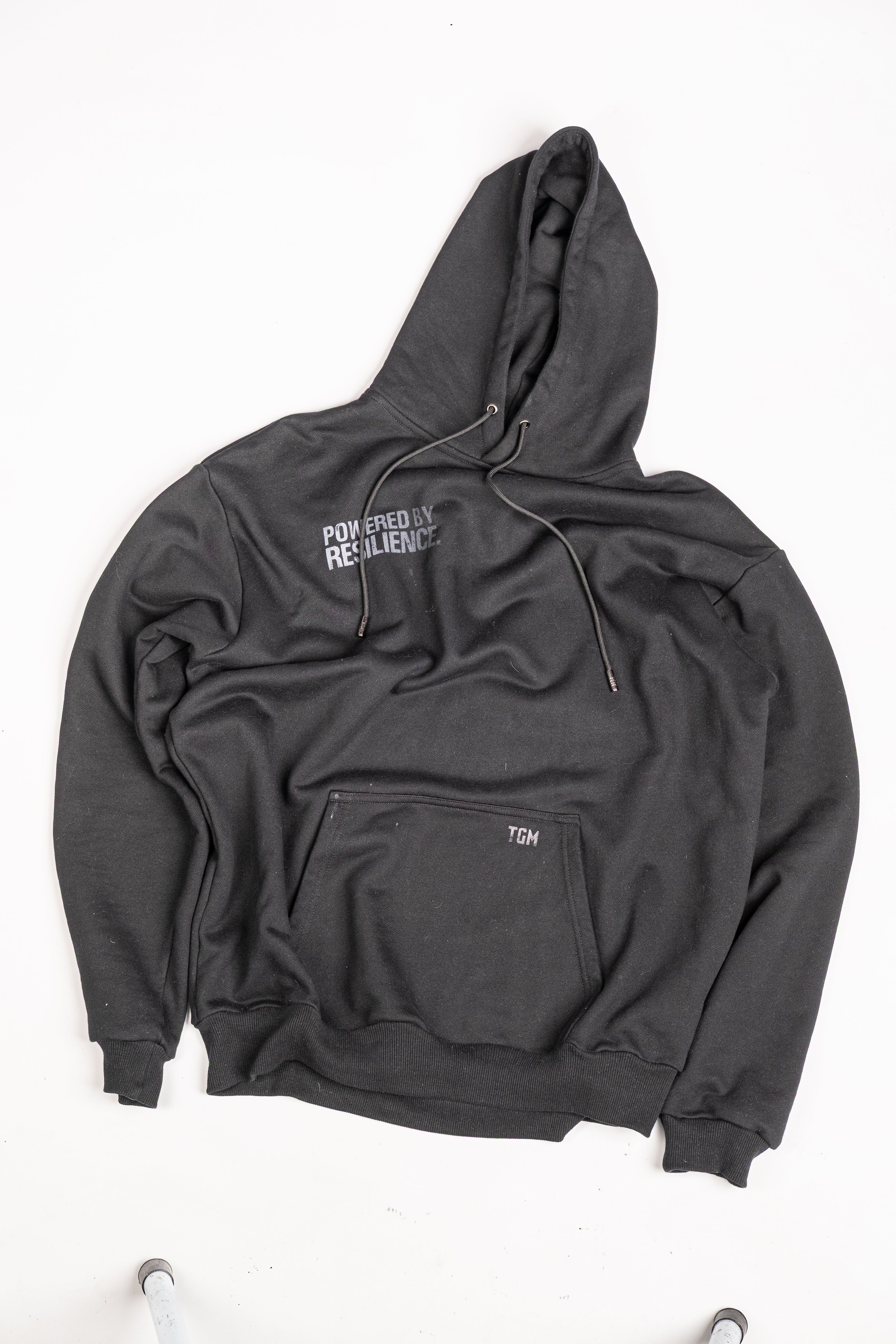 Black Oversized Hoodie with White gradient text saying powered by resilience. 100% premium cotton 