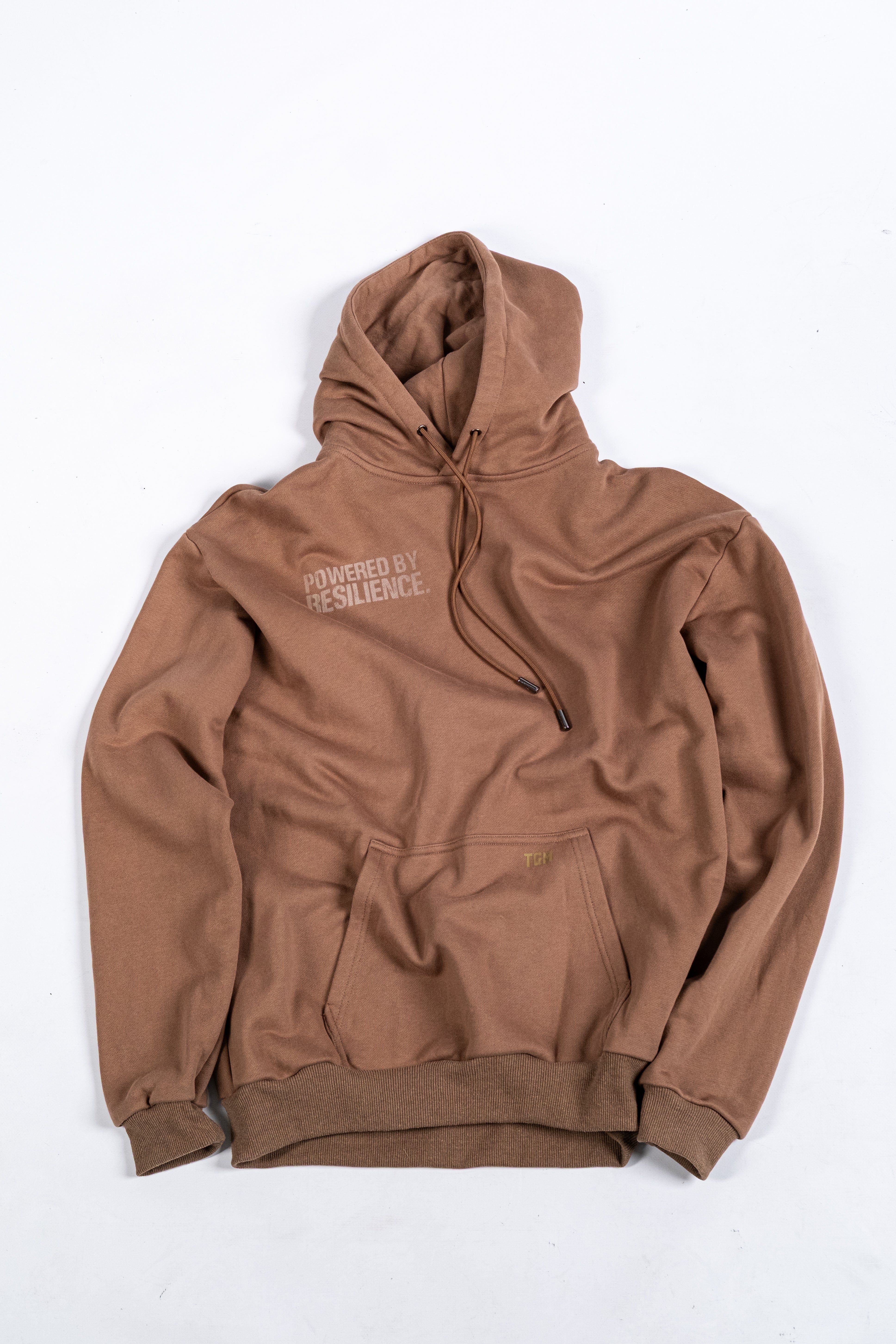 Brown Oversized Hoodie with white gradient text saying powered by resilience. 100% premium cotton